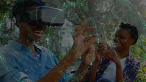 Animation-of-network-of-connections-over-african-american-woman-wearing-vr-headset-in-the-park