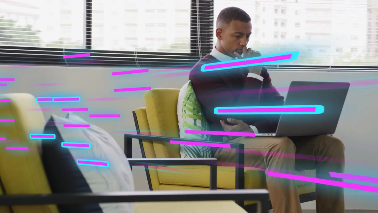 Man typing on laptop in yellow chair, pausing, reviewing tech, neon streaks sweeping left-to-right