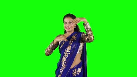 indian woman wearing sari clothes and dancing