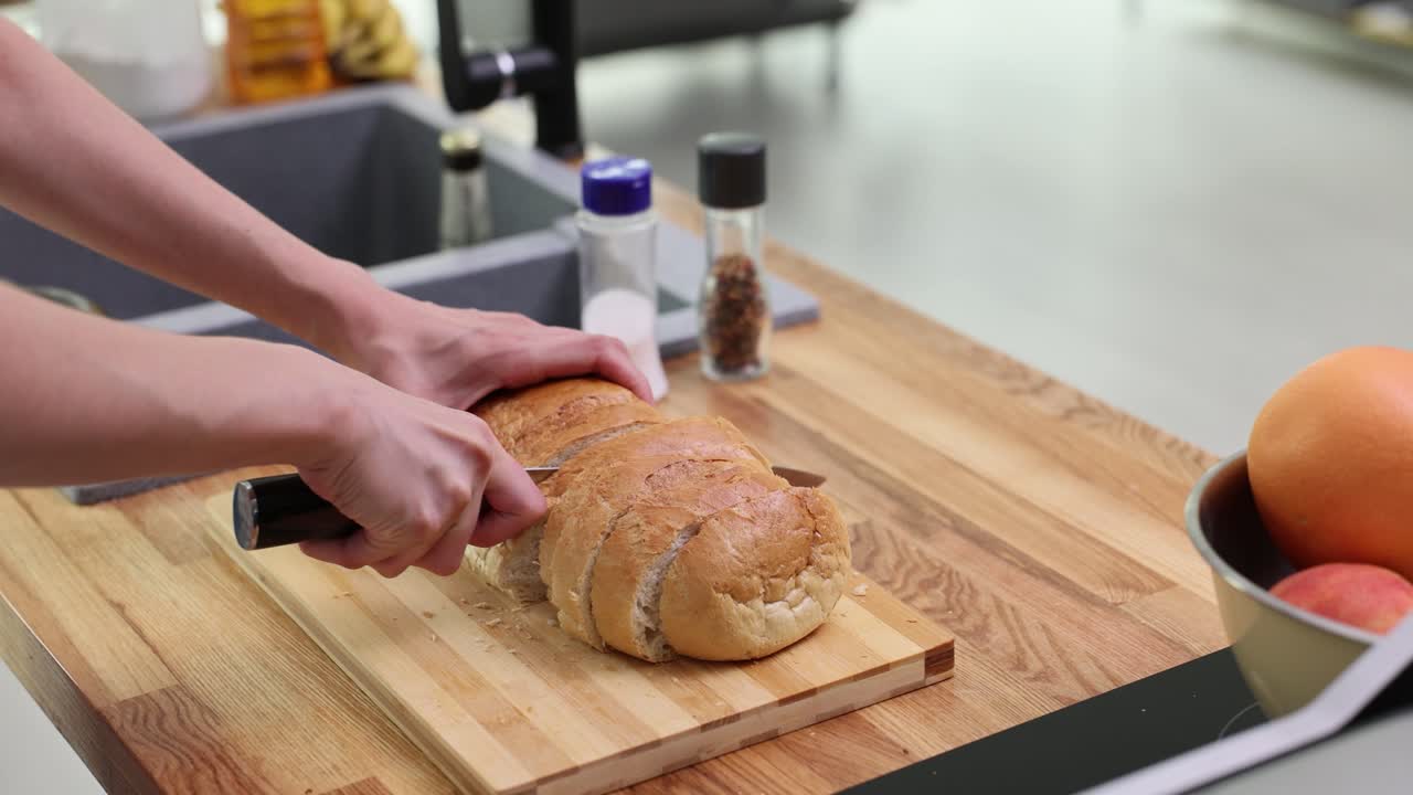 Cutting bread in the kitchen