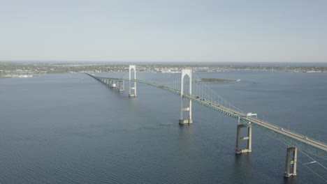 drone shot of a big bridge that crosses the water, moving forward and slowly tilting down