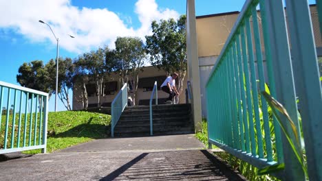 man does a trick on to the hand rail in hawaii