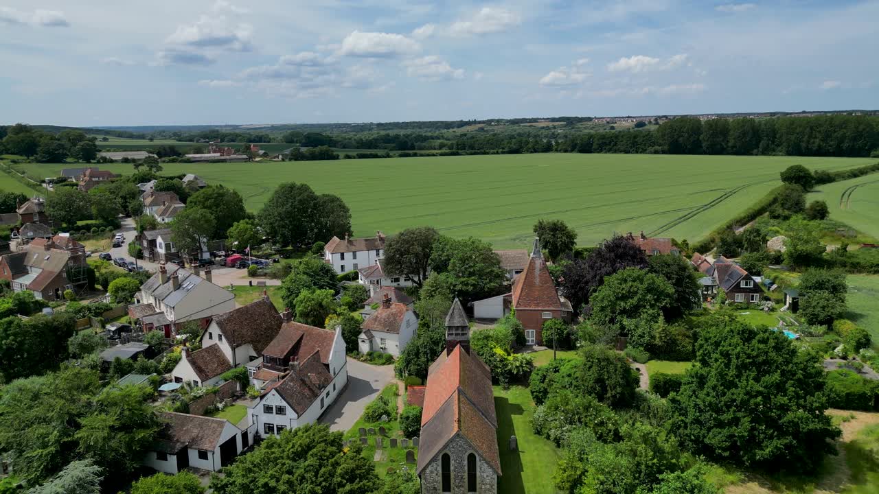 A push-in shot over St Mary's church and Stodmarsh towards a field
