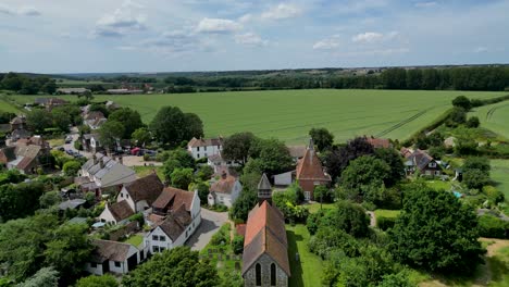 a push-in shot over st mary's church and stodmarsh towards a field