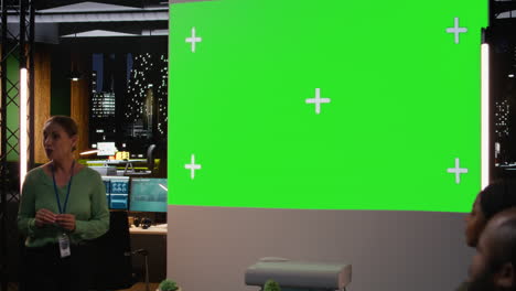 multiethnic people collaborating for a meeting at night with a green screen