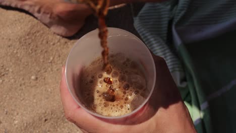 Pouring Soda on the Beach
