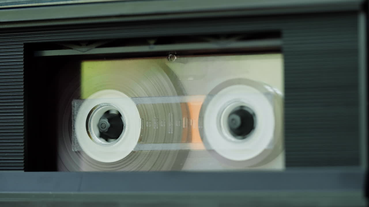 Close-up of an audio cassette tape in a cassette player