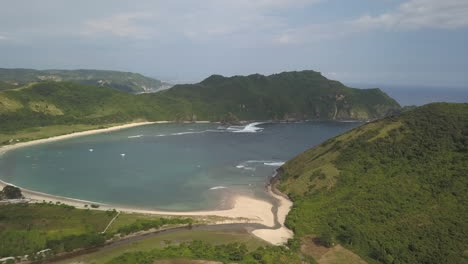 Orbiting-aerial-Shallow-river-enters-sandy-Areguling-Beach