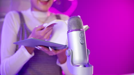 woman recording a podcast with microphone