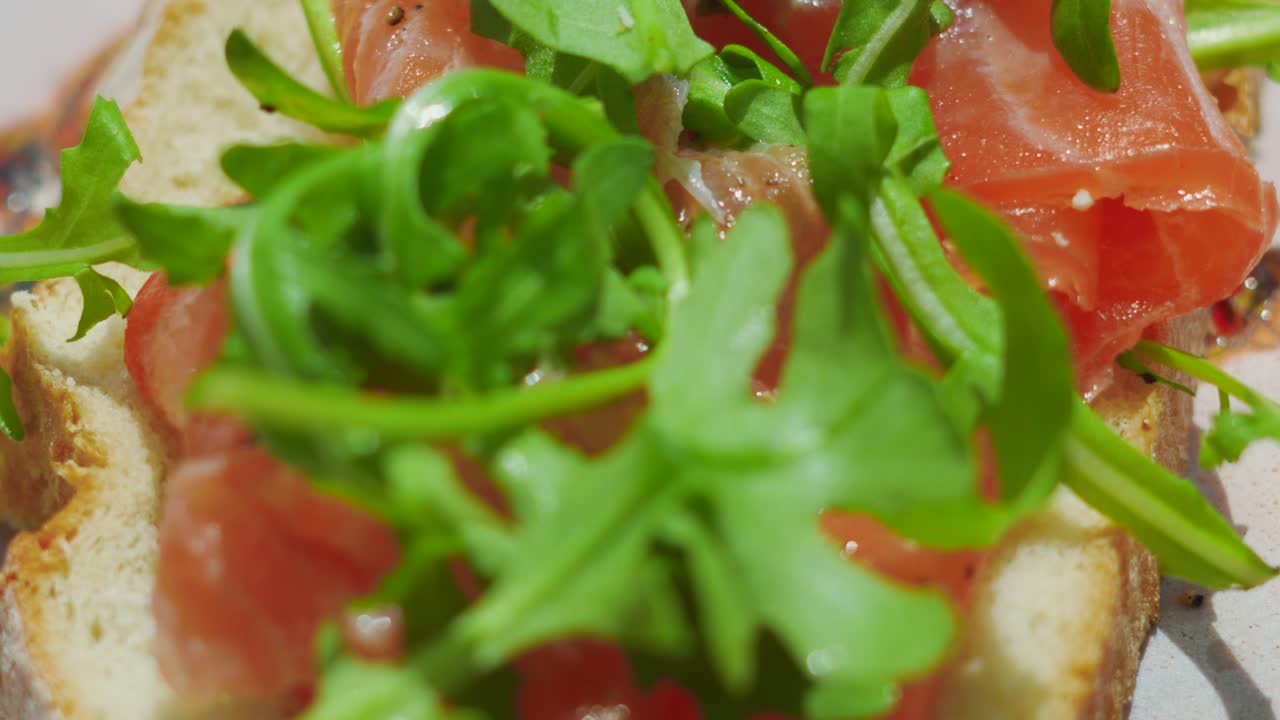 Top Down View of Freshly Sliced Bread with Smoked Salmon Topped with Rocket Salad. Healthy Organic Outside Eating.