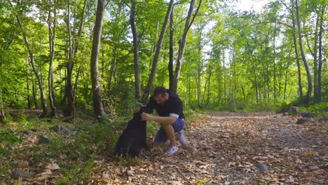 The-young-man-is-playing-with-the-dog-outdoors.