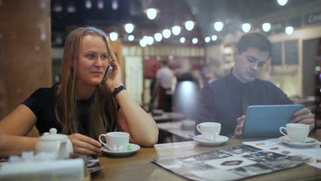 young people in a cafe with phone and tablet pc