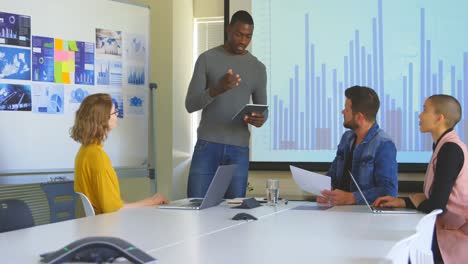 Young-mixed-race-business-team-planning-and-sitting-in-modern-office-4k