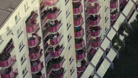 multi-story apartment building with pink balconies