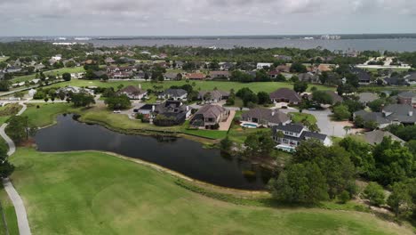 suburban golf community at residential area with water features and green lawns, panama city beach, florida, usa