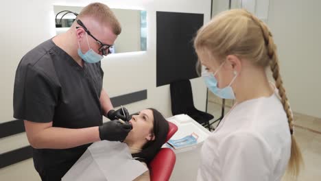 a qualified dentist performs a detailed oral examination in a bright, clean dental clinic, showcasing precision, modern equipment, and professional care.