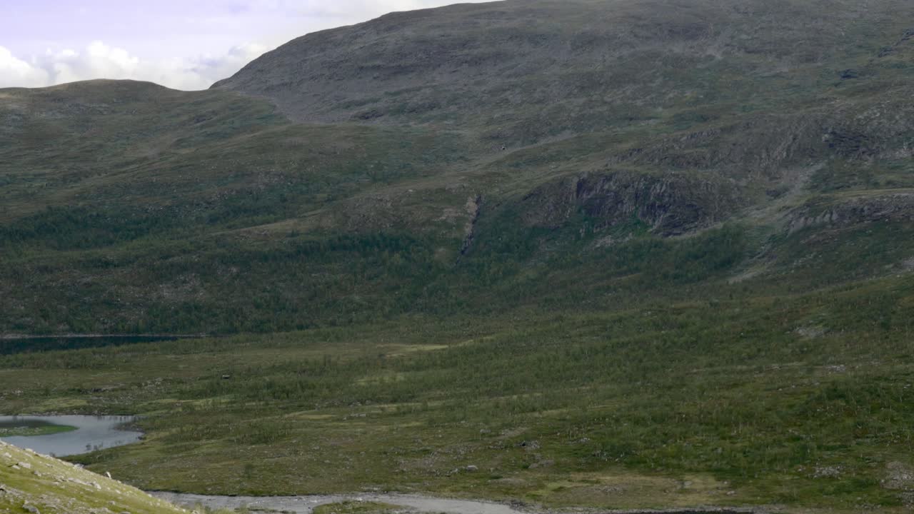 Helicopter rises over mountains in northern Sweden