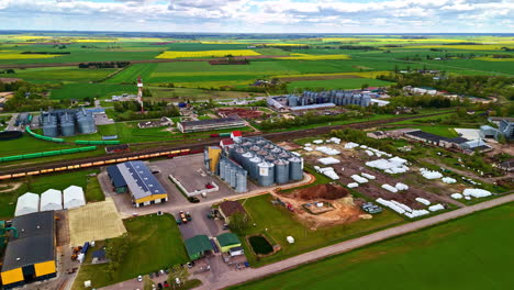 open field with greenhouses, farm roads, and silos forming rural agriculture hub