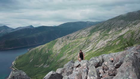 portrait of a norwegian guy mountaineering over kvaenan hiking trails in senja, norway