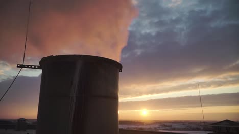 humo de la tubería industrial en los rayos del atardecer