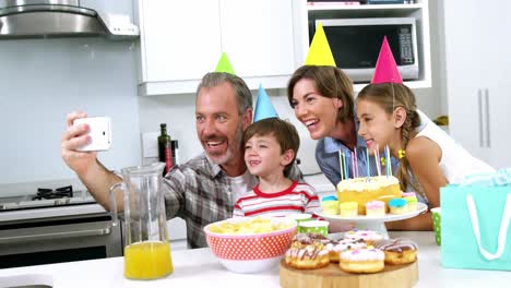 happy family taking a selfie on mobile phone