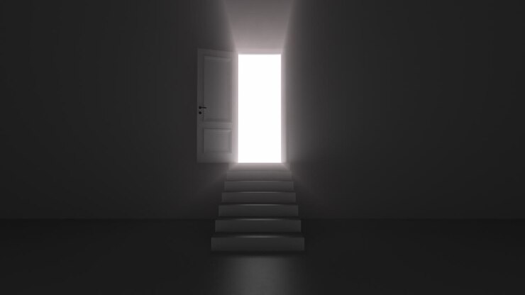 Shine of an open door with steps in a dark room
