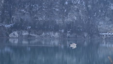 pequeno barco de pesca em frente a montanha maciça