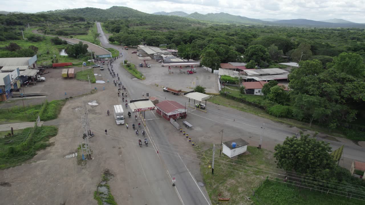 Aerial view of a gas station and road with vehicles
