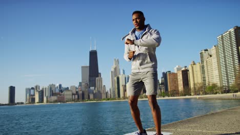 ethnic male running and stretching in chicago city