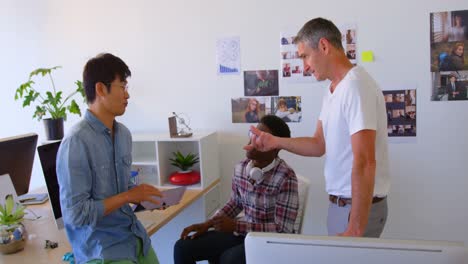 Multi-ethnic-business-colleagues-interacting-with-each-other-in-modern-office-4k