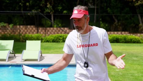 Lifeguard-holding-clipboard-and-whistling