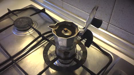 freshly brewed espresso in moka pot on stove