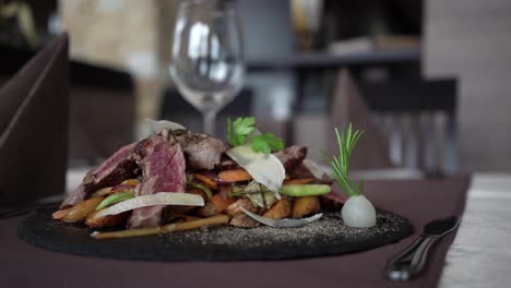 served roast beef on a black plate