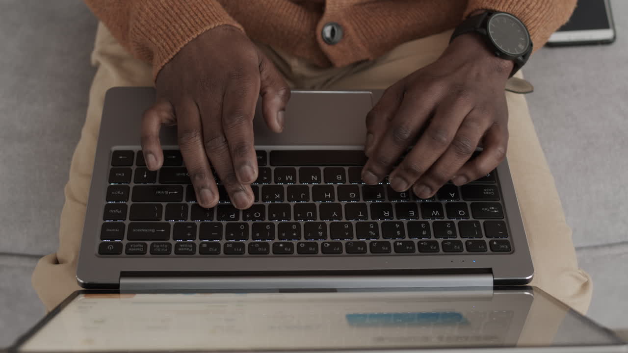 Unrecognizable African Man Working on Laptop