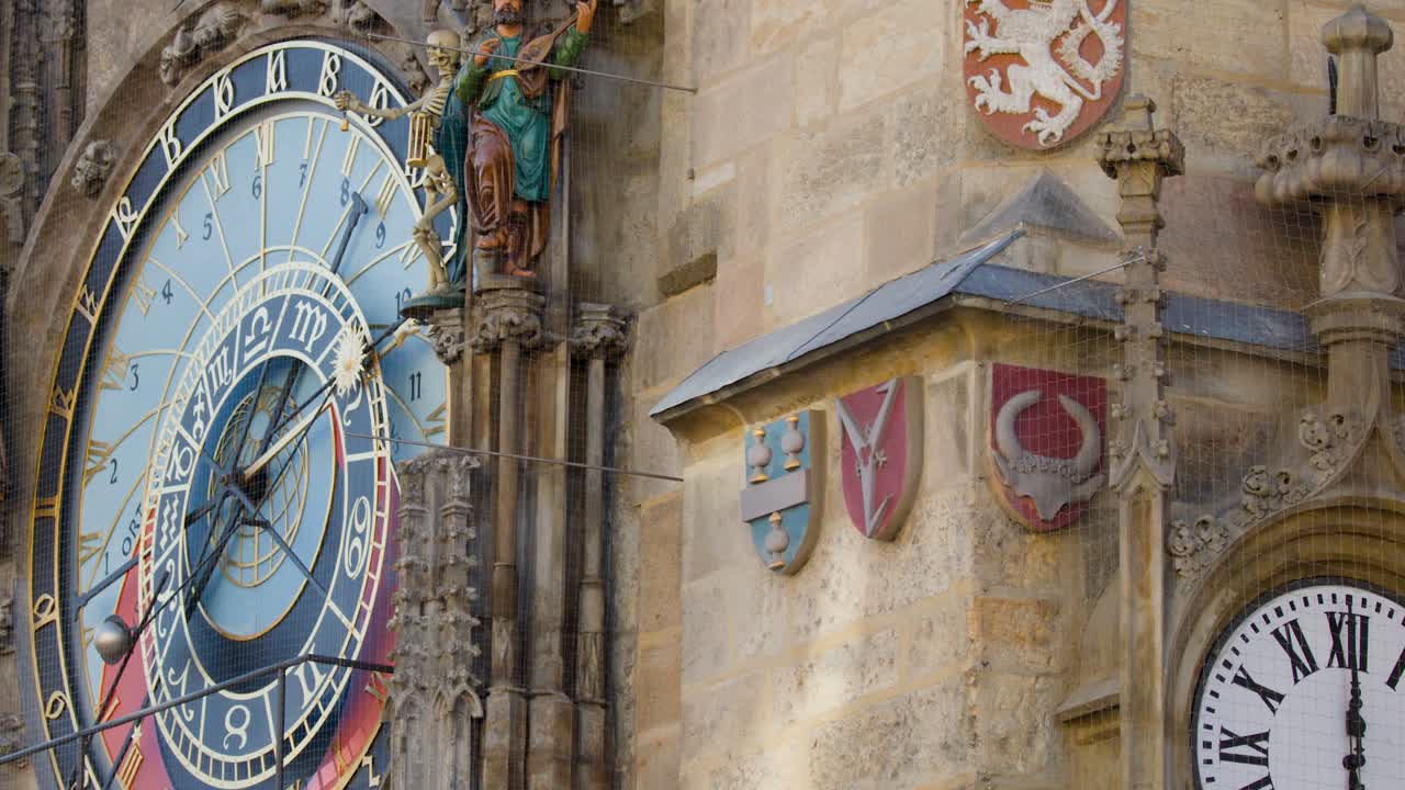 Close-up of animated statues and zodiac dial on medieval astronomical clock, daylight, slow camera pan