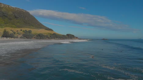 aerial: surfers at mount maunganui beach, new zealand