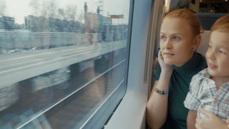 Mother-and-son-traveling-across-the-city-by-train