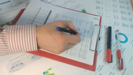 hands marking data in a business report