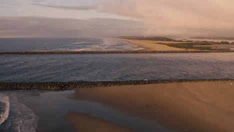 aerial of coos bay harbor entrance during a dramatic and beautiful winter sunset