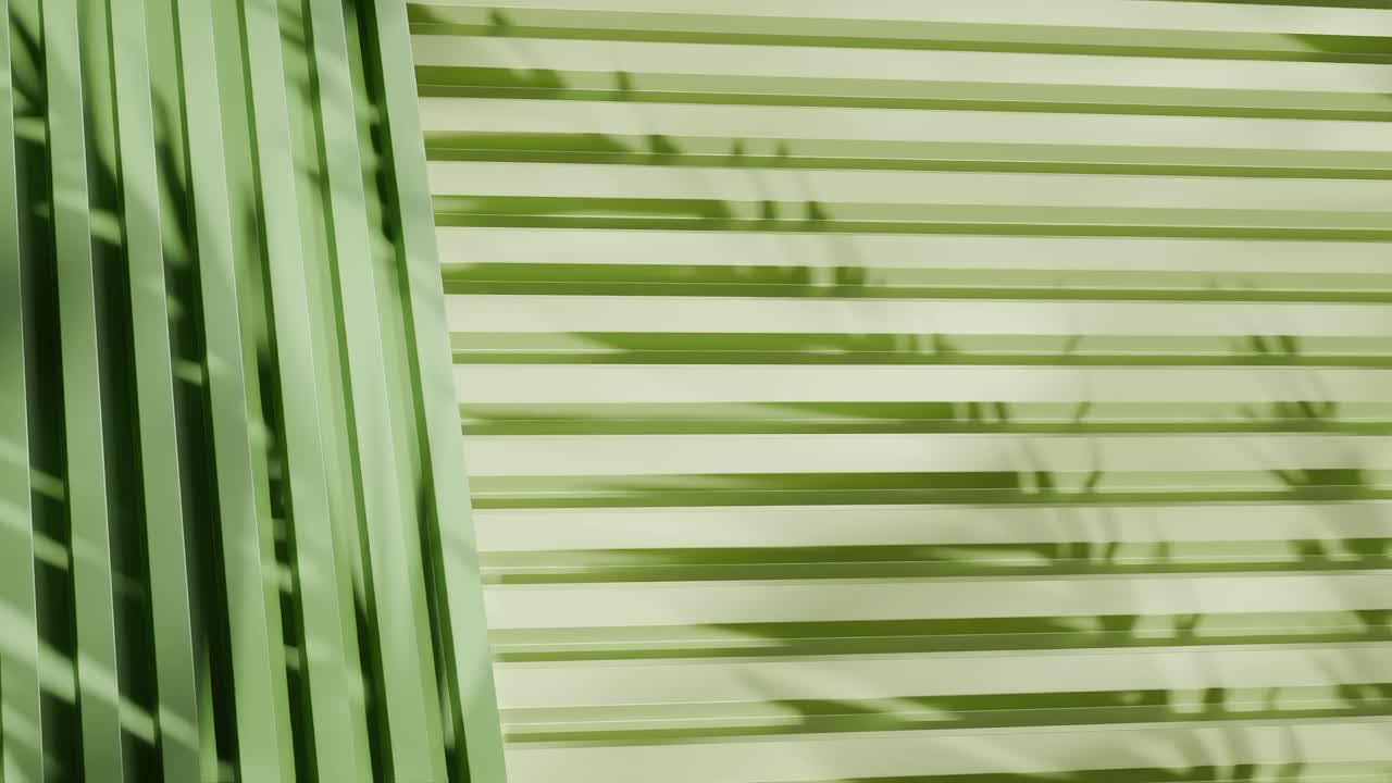 green vertical metal panels with shadows of tropical leaves. Abstract architectural detail. Close-up photography with copy space for design and print