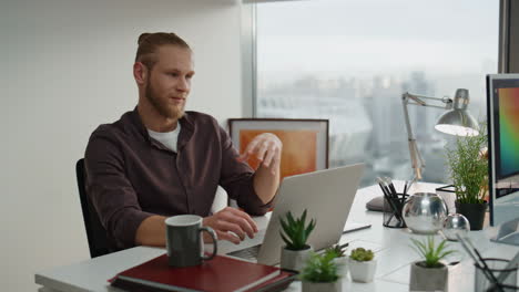 Resting-designer-speaking-at-laptop-close-up.-Smiling-woman-listening-colleague