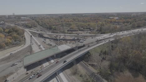 us 127 trowbridge exit bridge and freeway construction with traffic driving and drone video moving in a circle.