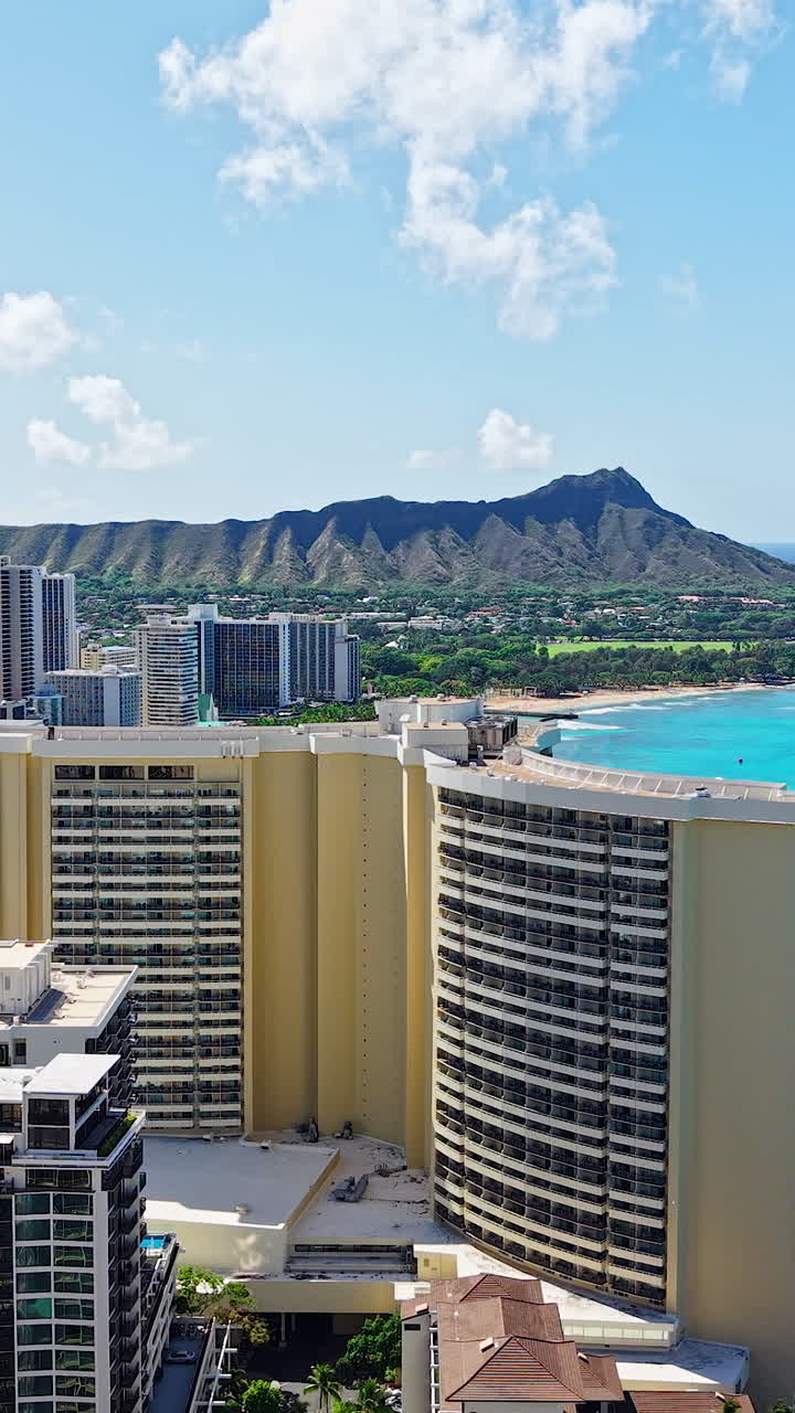 Vertical Drone Shot of Honolulu, Hawaii USA Hotels and Condominiums by Waikiki Beach With Diamond Head in Background