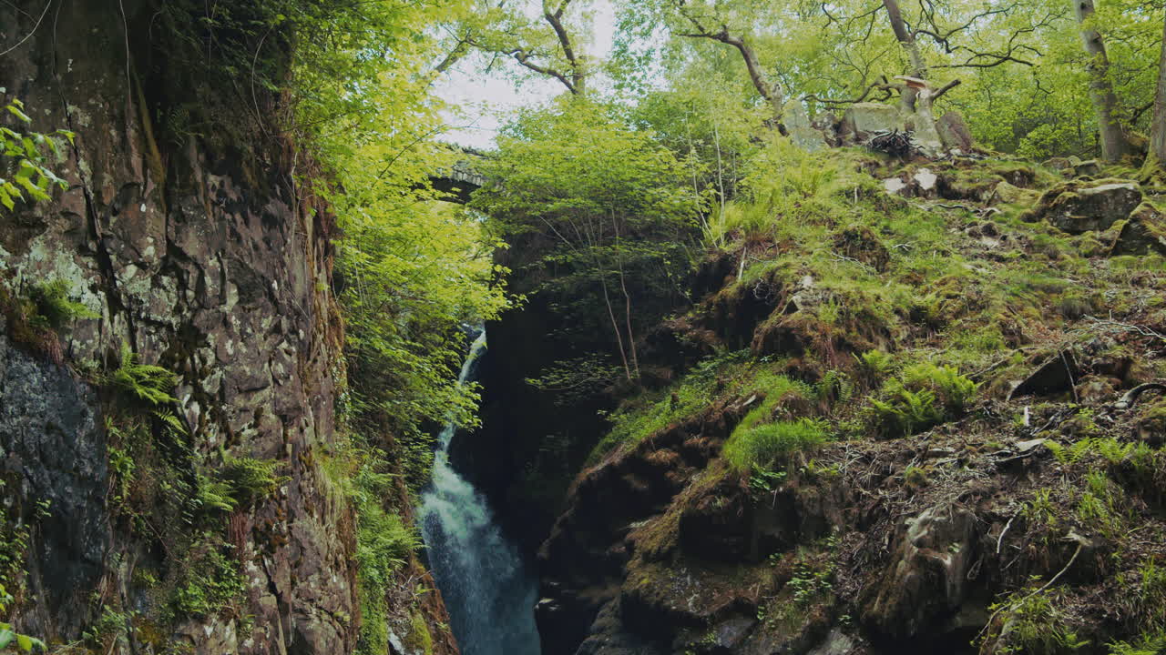 Slow motion panning shot of English waterfall Aira Force, Cumbria