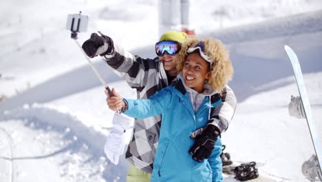 fun young couple posing in the snow for a selfie