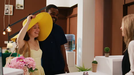 Diverse-couple-entering-hotel-lobby