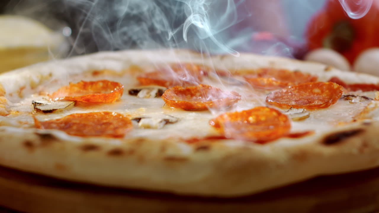 Close up of a steaming pepperoni pizza