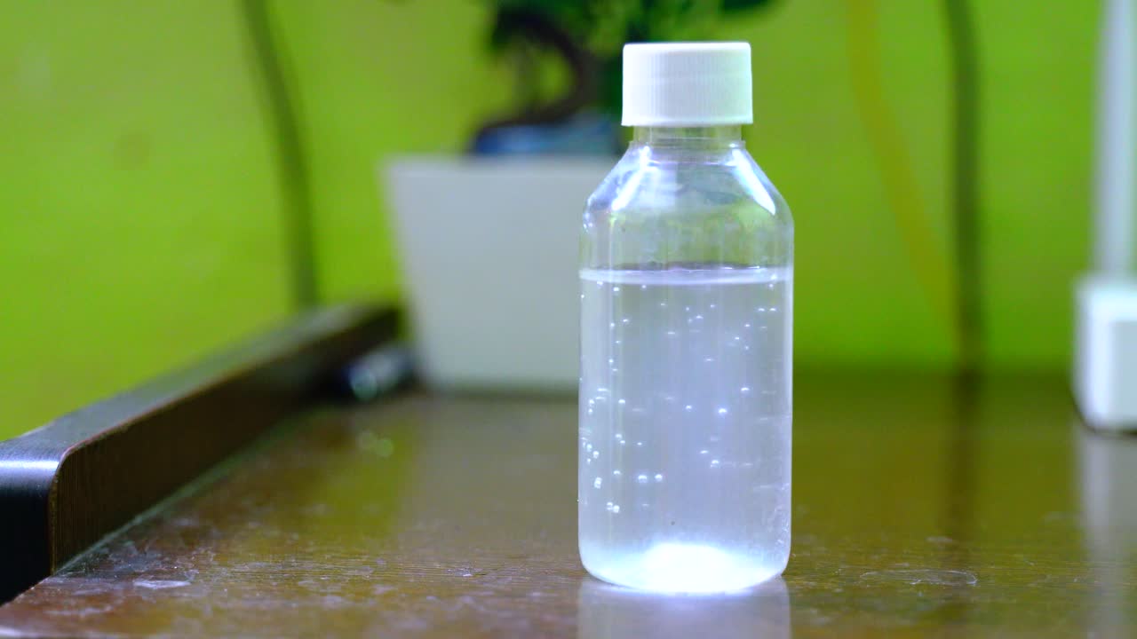 Coronavirus hand sanitizer sanitiser gel for clean hands hygiene corona virus spread prevention. Woman using alcohol rub alternative to washing hands.