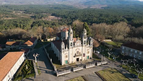 drone orbit around gothic style cathedral of carved stone in ourense spain, long shadows