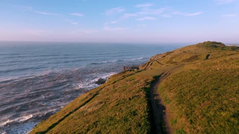 amazing sunrise of cliffs on atlantic ocean establishing beautiful aerial cinematic view, guarita park, brazilian conservation unit in torres, rio grande do sul